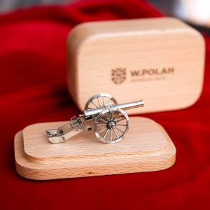 A detailed miniature cannon model on a wooden stand, epitomizing precision craftsmanship.