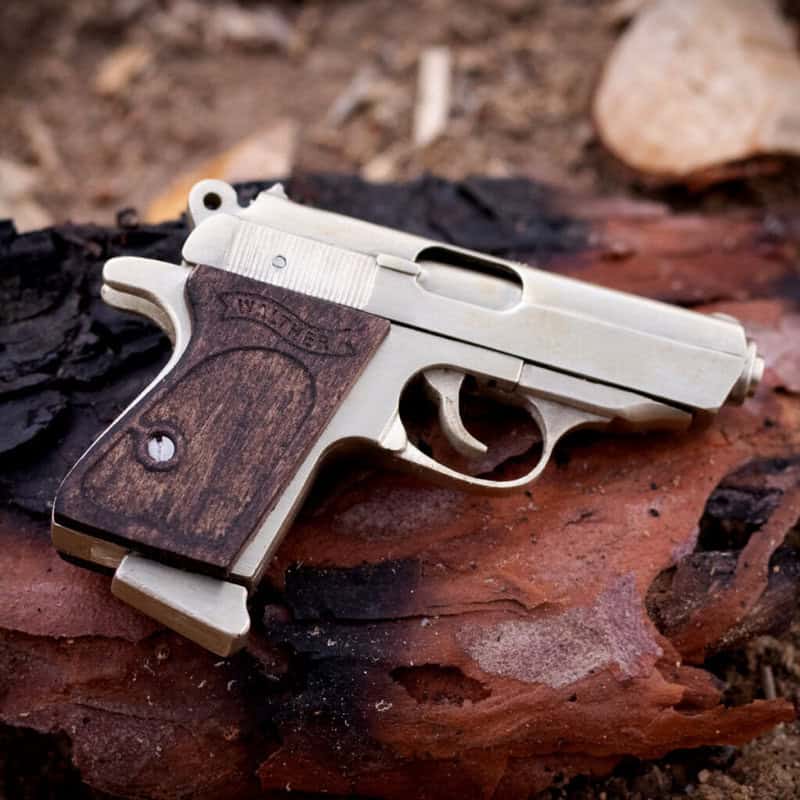 The Walther PPK miniature slide pistol is a full metal gun detailed wood grips.