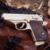 The Walther PPK miniature slide pistol is a full metal gun detailed wood grips.