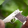 The Walther PPK miniature slide pistol is a full metal gun detailed wood grips.