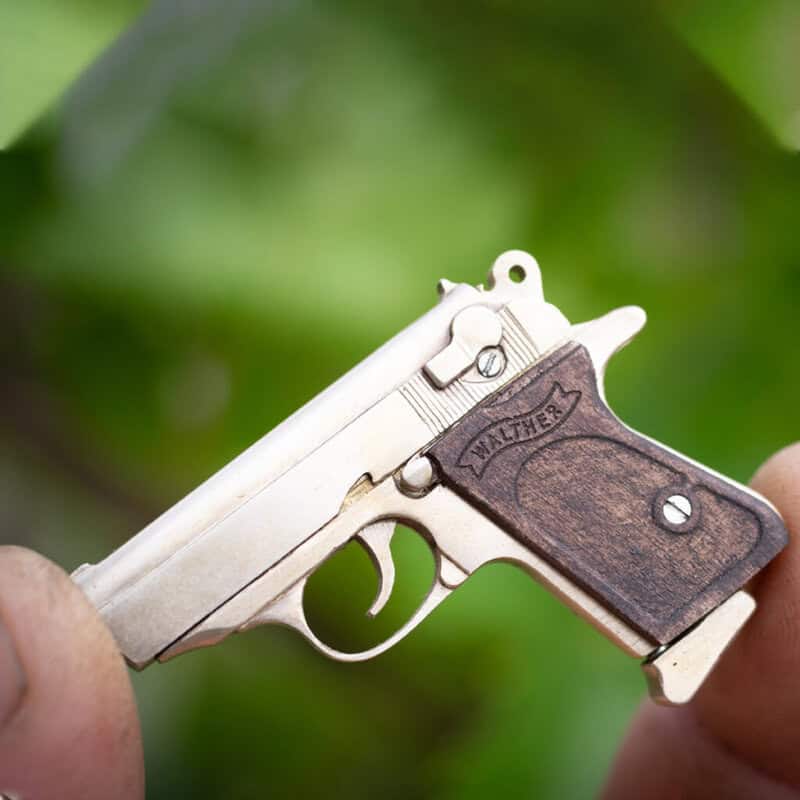 The Walther PPK miniature slide pistol is a full metal gun detailed wood grips.