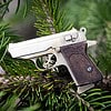 The Walther PPK miniature slide pistol is a full metal gun detailed wood grips.