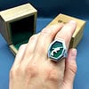 Large Silver Locket Ring with Derringer inside on backing green fabric