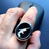 Silver Locket Oval Ring with Derringer inside on backing black fabric