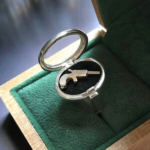 Silver Locket Ring with Glass — opened, with Miniature Derringer Pistol inside