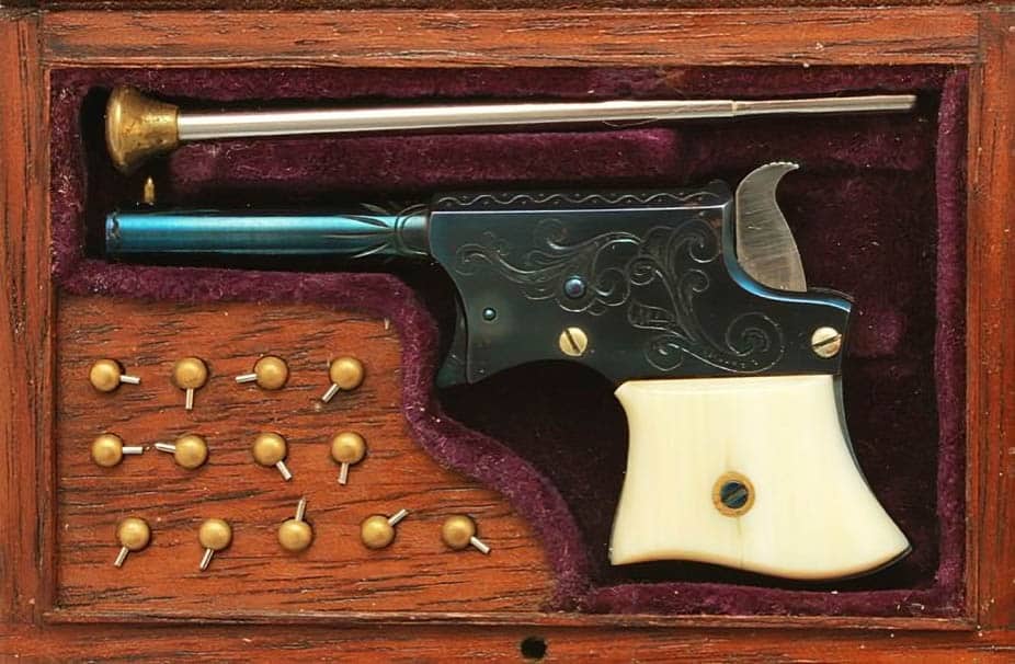 It’s a 1/3 scale Remington Elliot Derringer modified by Larry Smith to fire a 2 mm pinfire cartridge. It has blued frame, barrel and trigger.