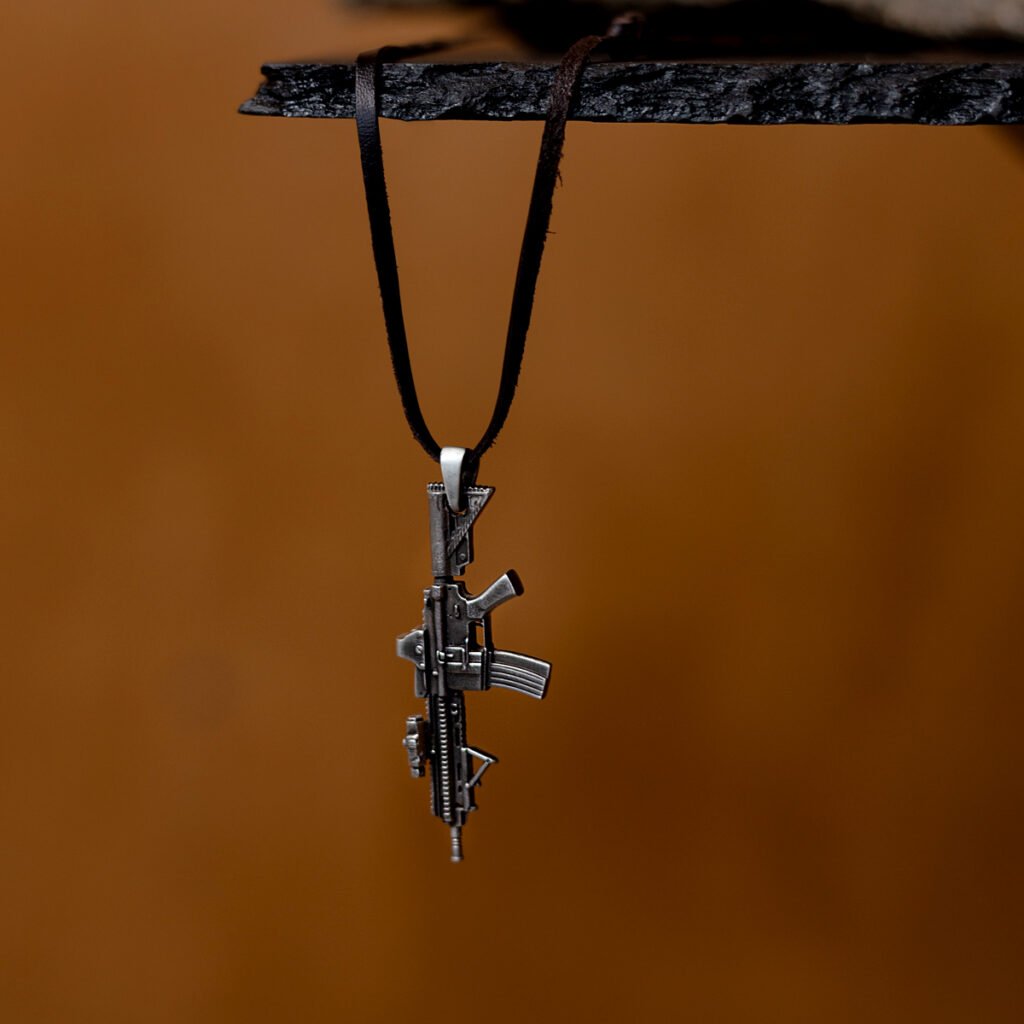 A silver HK416 rifle pendant hanging from a leather cord